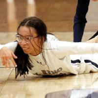 Tetona Blackowl attempts to swipe the basketball toward a teammate