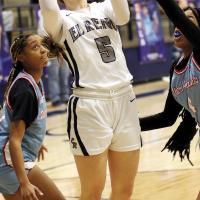 Raegan Bugaj slips between two Western Heights defenders to get off a shot