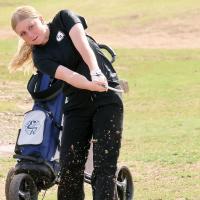 Radley Miller watches a chip shot fly toward the hole