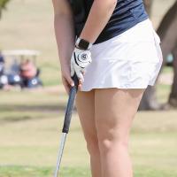 Lily Elliott watches a putt roll toward the hole