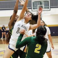 Leslie Valdez throws up a shot while being fouled