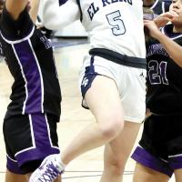 Raegan Bugaj has her glasses knocked off while shooting through a double team