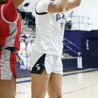 Sasha Elledge tries to push up a shot through a block attempt