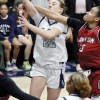 Kassidy Ferguson takes a forearm to the face while shooting a jumper