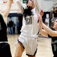 Tetona Blackowl splits defenders to shoot a jumper in the lane