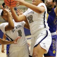 Pauline Black-Harmon pulls down a rebound in front of Janae Black-Harmon