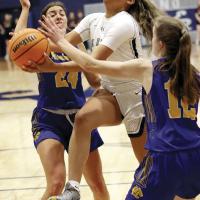 Pauline Black-Harmon keeps the ball low as she jumps under two defenders
