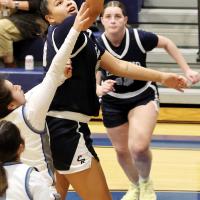 Lilly Thomas shoots a fastbreak layup over a Southeast defender