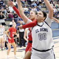 Lilly Thomas has her arm hooked by a Duncan player as the two battle for a rebound