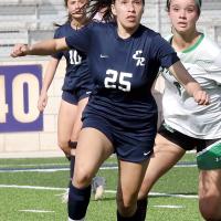 Leslie Valdez eyes a high bouncing ball
