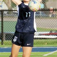 Zanora Santos uses her upper body to control a long goal kick