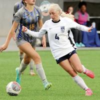 Lily Hayes spins around a Classen SAS defender en route to a shot attempt