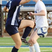 Karsyn Conner kicks the ball sideways around a Classen SAS defender