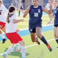 Madison Rochdi leaps to the side after passing the ball
