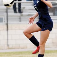 Caroline Huber jumps up into the air to control a kick