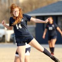 Bri Vickers grimaces after using her forehead to redirect a goal kick