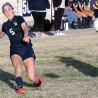 Caroline Huber kicks the ball past a defender