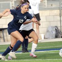 Kristina Conner dribbles between a pair of Southeast players