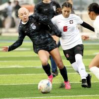 Lily Hayes gets shoved in the back by a U.S. Grant player while dribbling the ball
