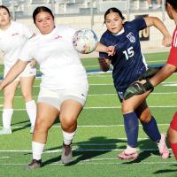 Lilyana Menjivar challenges a Western Heights defender as she tries to chase down a loose ball