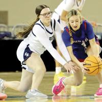 Raegan Bugaj reaches out to try and knock the ball away from a Durant player
