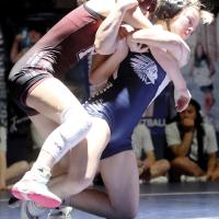 Brooklynn Huggins hooks the arms of Perry’s A.J. Wasen as she leans into a takedown move