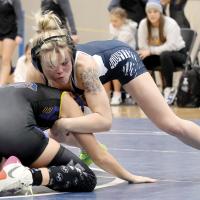 Brooklynn Huggins works on the shoulders of Carissa Martin during their 110-pound match