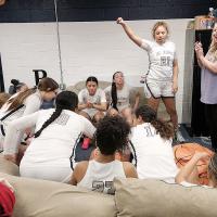 Jennifer Douglas talks with players in the locker room