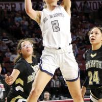 Ashlyn Evans-Thompson shoots between two McAlester defenders