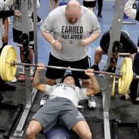Latin Everheart pushes up a bar of weights