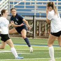 Conley Knapp leaps into the air as she follows through on a shot on goal