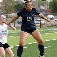 Lily Menjivar uses her head to redirect a throw-in pass