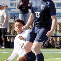 Luke Lemke (13) collides with a Lawton player as the ball flies free
