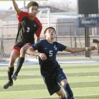 A Tuttle player leaps over the back of EHS’ Diego Reyes