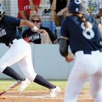 Justine Johnson drops down a bunt attempt as teammate Iliana Ashford watches