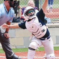 Kallie DeShields reaches up to snag a high pitch