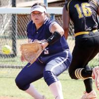Micah Woods eyes a throw to first base as a runner from Lawton MacArthur beats out the throw