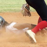 Sarah Hernandez squints as she slides through a cloud of dust