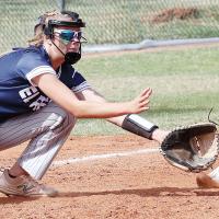 Iliana Ashford reaches out to snag a throw while covering third base