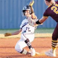 Izzy Choat tries to slide under a tag by a Clinton infielder