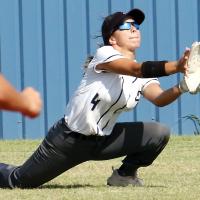 Krystiana Guzman slides down to her knees to try and scoop up a hit