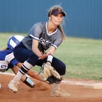 Julie Holdcraft squats to snag a pickoff throw to first