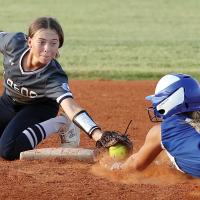 Ryah Hardy reaches to place her glove in front of a base runner