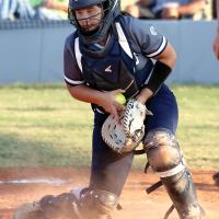 Bailey Brothers grabs the ball out of her glove after blocking a throw to home