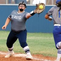 Raley Hartley reaches out to snag a throw to the bag in front of a runner