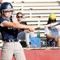 Hayden Wyles watches the ball fly off her bat after making contact