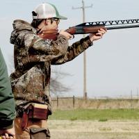 A puller waits for Kenyon Burt to call for a clay pigeon