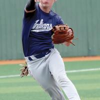Austin Steffler jumps into the air as he makes a throw to first base