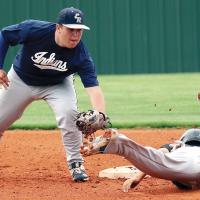 Trevor Felz squeezes the ball in his glove as he reaches to tag a base runner