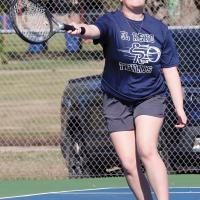 Serenity Billings reaches out to hit a forehand return shot